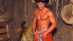 Handsome young cowboy displays his muscled body and strokes his cock