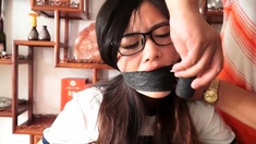 Gir taped to chair and gagged