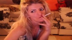 Smoking blonde stripteasing and having fun on webcam