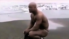 Asian bodybuilder barely covered at the beach